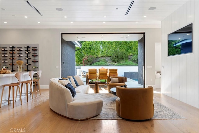 living area featuring recessed lighting, wood ceiling, and light wood finished floors