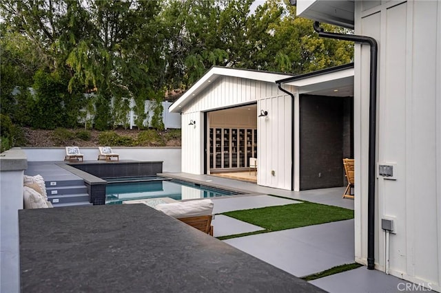 outdoor pool with a patio area