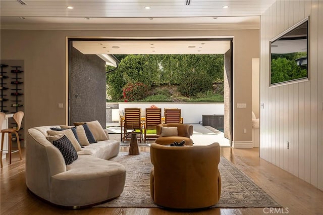 interior space featuring a wealth of natural light, ornamental molding, and wood finished floors