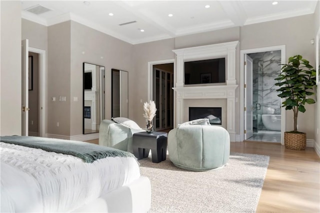 bedroom with light wood-type flooring, ornamental molding, a fireplace, and baseboards