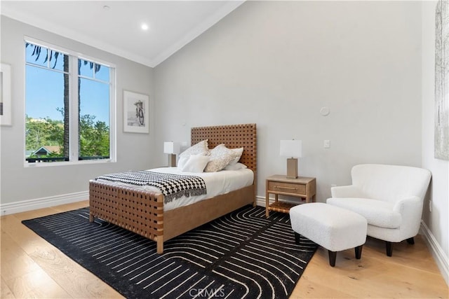 bedroom with lofted ceiling, recessed lighting, baseboards, and wood finished floors