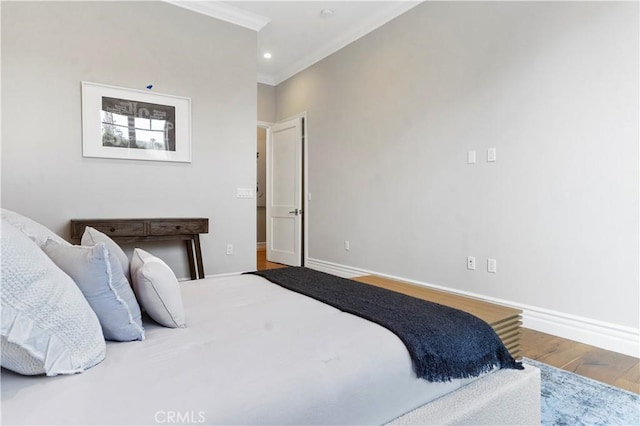 bedroom with ornamental molding, recessed lighting, wood finished floors, and baseboards