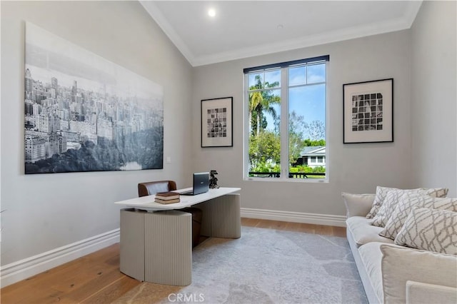 office space with baseboards, light wood-style flooring, and a healthy amount of sunlight