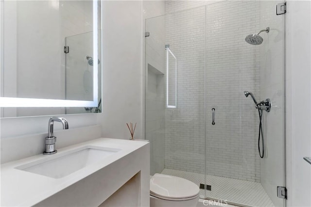 full bath featuring toilet, a shower stall, and vanity