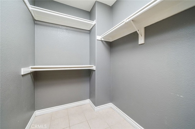 spacious closet with tile patterned floors