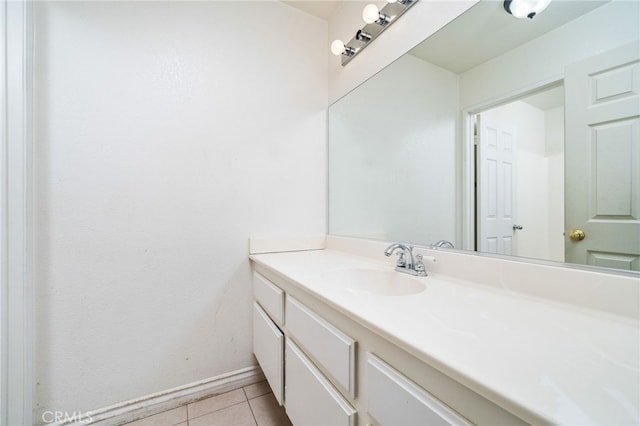 bathroom featuring vanity, baseboards, and tile patterned floors