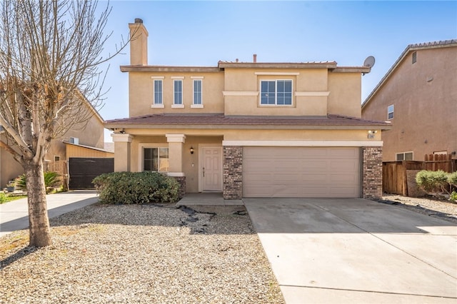 view of front facade with a garage, concrete driveway, stucco siding, fence, and brick siding