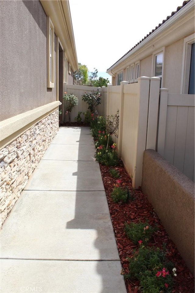 view of home's exterior featuring fence and stucco siding