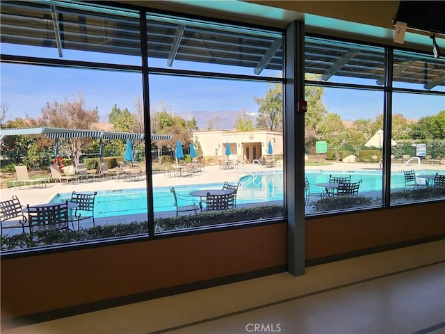 view of swimming pool with a mountain view
