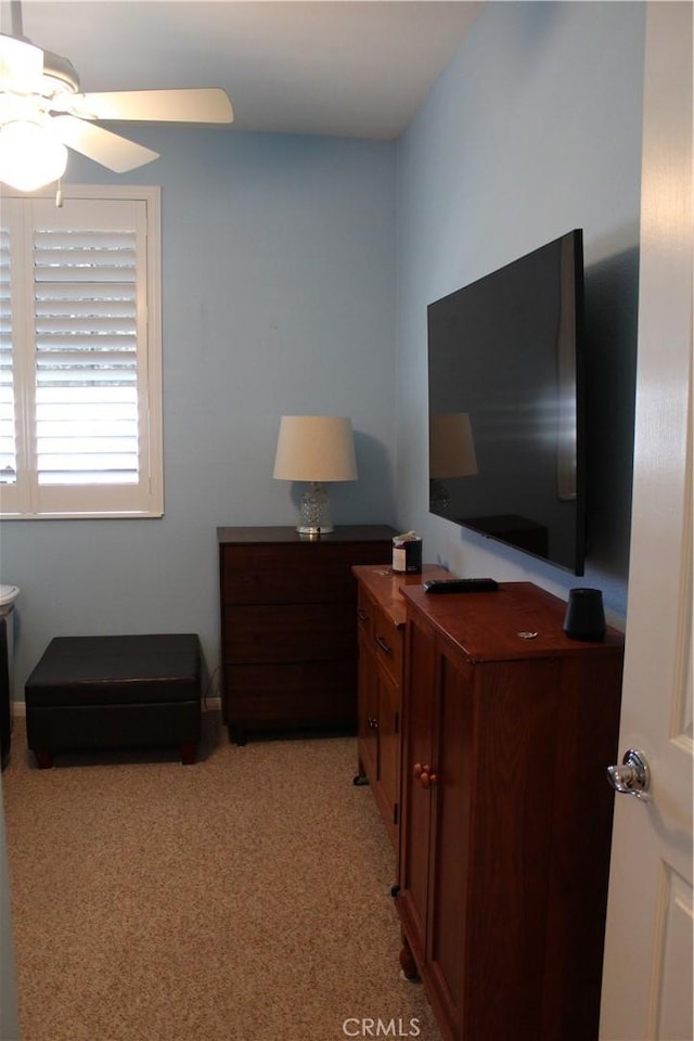 bedroom with a ceiling fan and light colored carpet