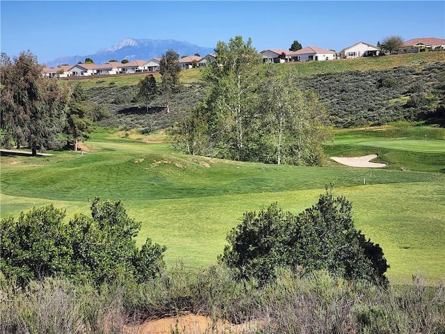 view of property's community featuring a mountain view and a lawn