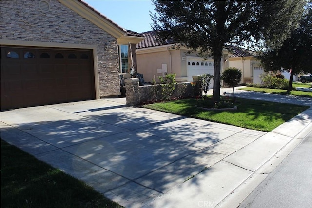 ranch-style home featuring driveway, a garage, stone siding, a tiled roof, and stucco siding