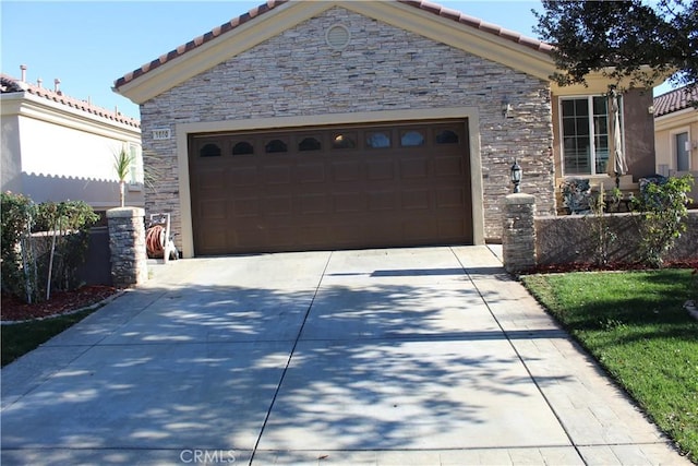 view of front of home featuring driveway, stone siding, an attached garage, and a tiled roof