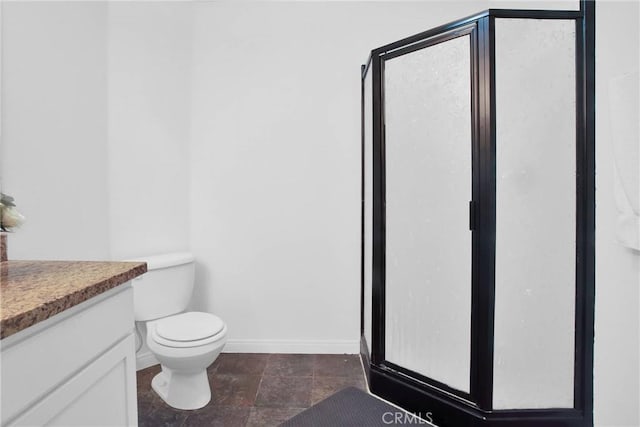 full bathroom with toilet, vanity, baseboards, and a shower stall