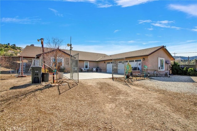 7575 Rancho Rd, Wrightwood, CA 92372 - rear view of property featuring an attached garage and driveway