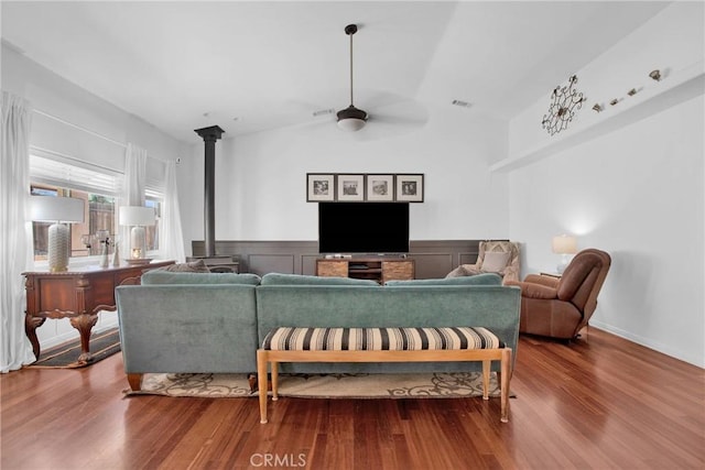 7575 Rancho Rd, Wrightwood, CA 92372 - living area with a wood stove, ceiling fan, wood finished floors, wainscoting, and lofted ceiling