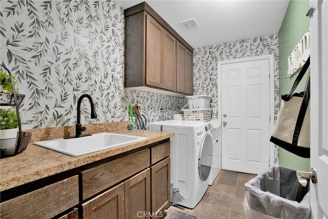 7575 Rancho Rd, Wrightwood, CA 92372 - laundry area with wallpapered walls, cabinet space, washing machine and clothes dryer, and stone finish flooring