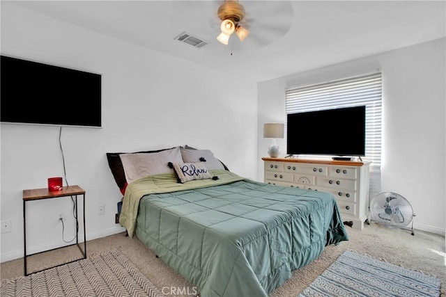 carpeted bedroom with baseboards, visible vents, and a ceiling fan