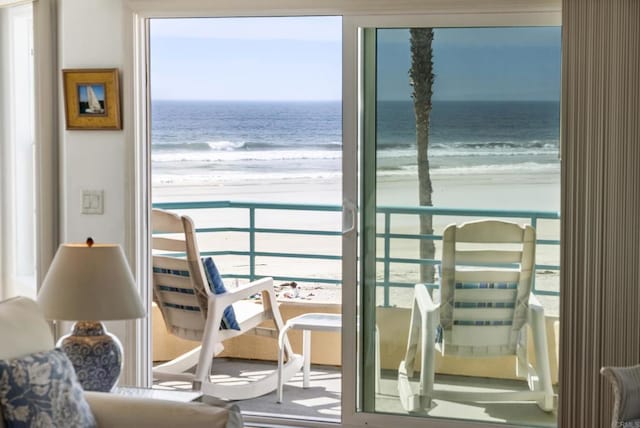 interior space with a water view and a beach view