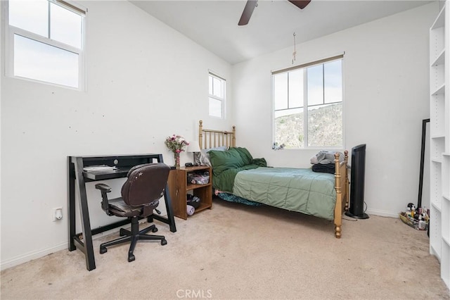 carpeted bedroom with baseboards and a ceiling fan