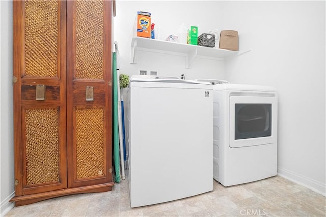 laundry room featuring laundry area, independent washer and dryer, and baseboards