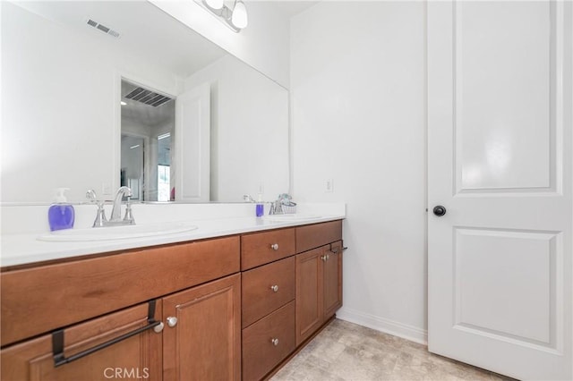 full bathroom featuring double vanity, visible vents, and a sink