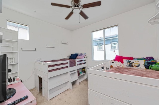 bedroom with light carpet and a ceiling fan