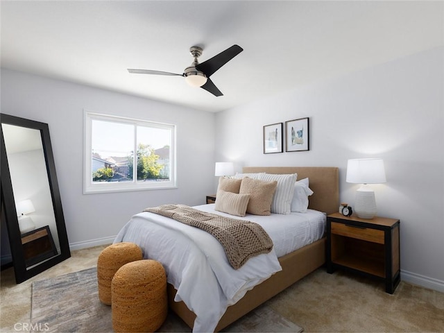 bedroom featuring light carpet, ceiling fan, and baseboards