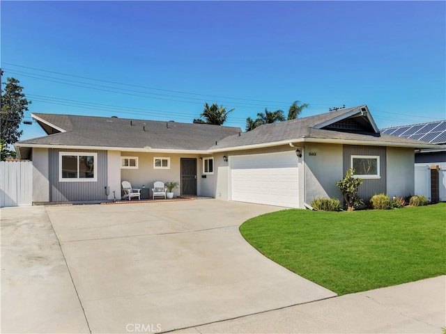 ranch-style home with a garage, concrete driveway, a front lawn, and fence