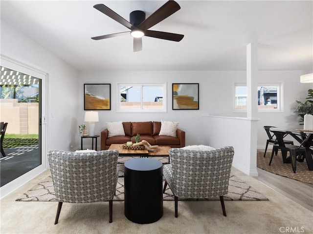 living area featuring ceiling fan and baseboards