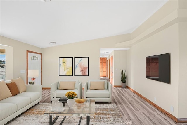 living room featuring light wood-style flooring and baseboards