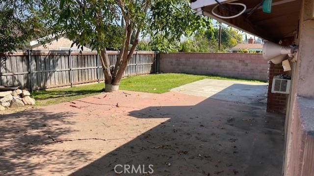 view of yard with a fenced backyard and a patio