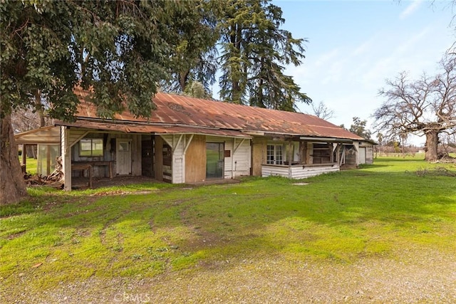 view of front of property featuring a front yard and metal roof