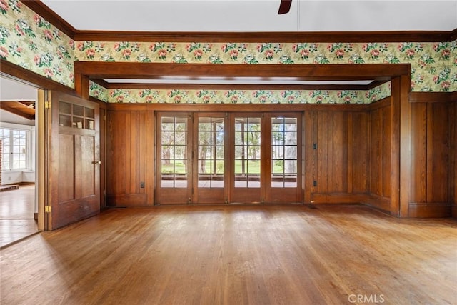 unfurnished room featuring crown molding, light wood finished floors, and wallpapered walls