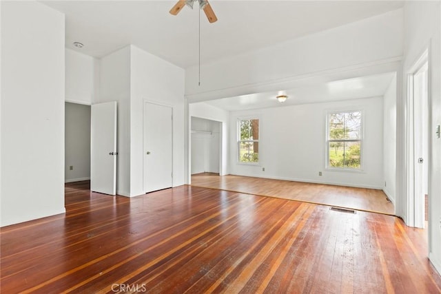 empty room featuring visible vents, ceiling fan, and hardwood / wood-style flooring