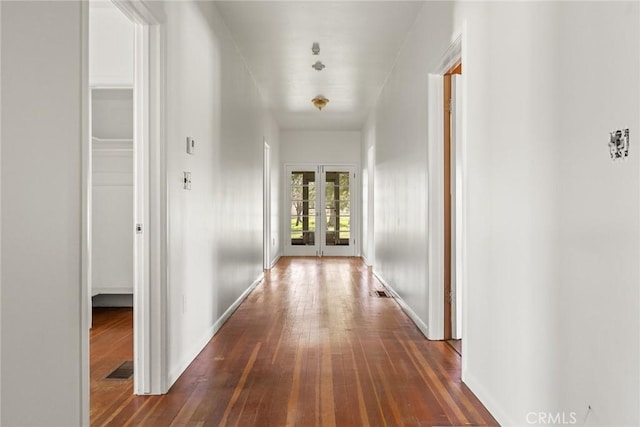 corridor with dark wood-style flooring and french doors