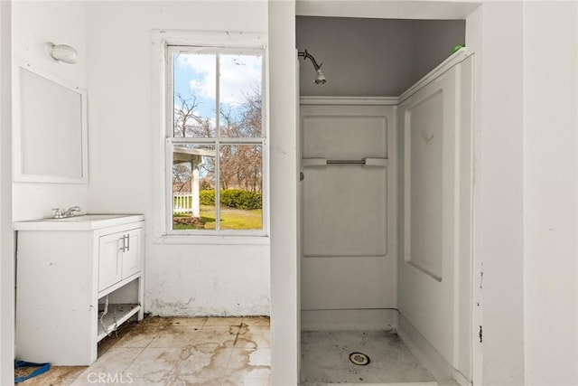 bathroom with a shower and vanity