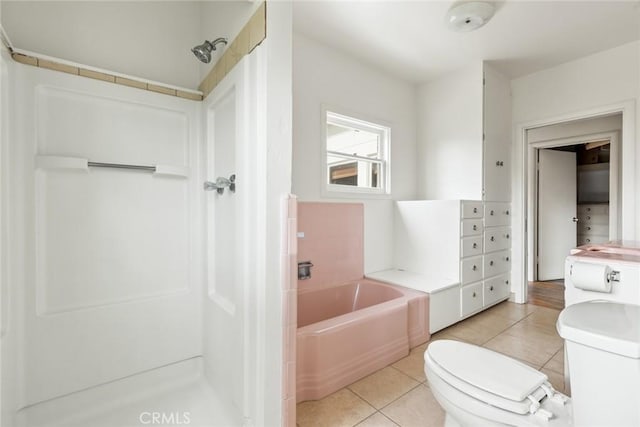 bathroom with toilet, a garden tub, a shower, and tile patterned floors