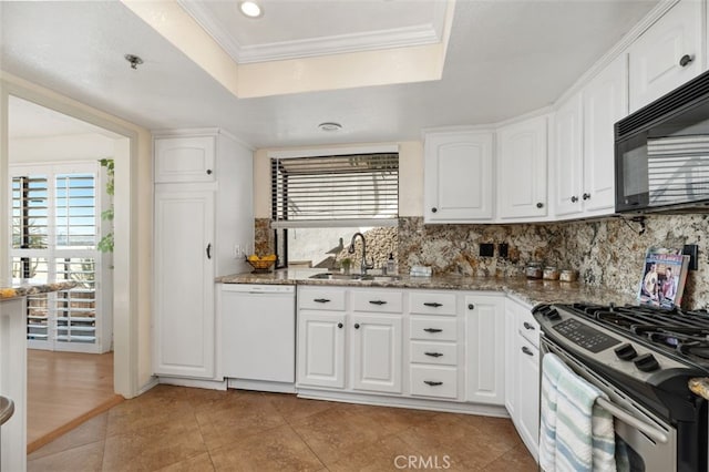 kitchen with black microwave, white dishwasher, a sink, stainless steel gas range, and a raised ceiling