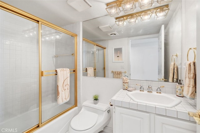 full bathroom featuring combined bath / shower with glass door, backsplash, vanity, and toilet