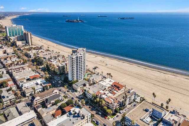 aerial view featuring a view of the beach, a water view, and a view of city