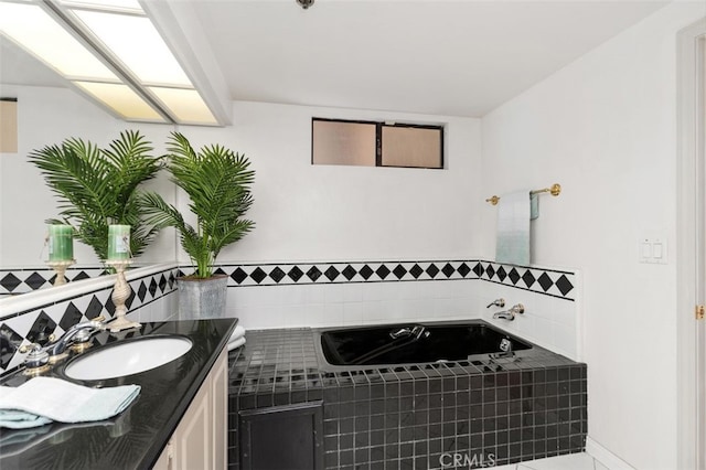 bathroom with a garden tub and vanity