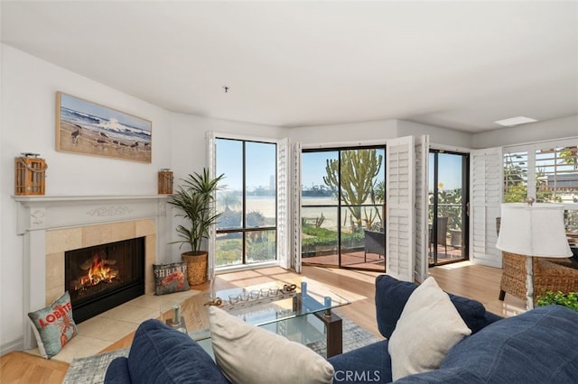 living area with wood finished floors and a tile fireplace