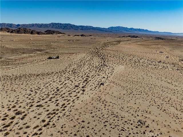 aerial view featuring a mountain view and view of desert