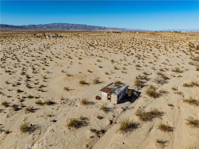 drone / aerial view with view of desert and a mountain view