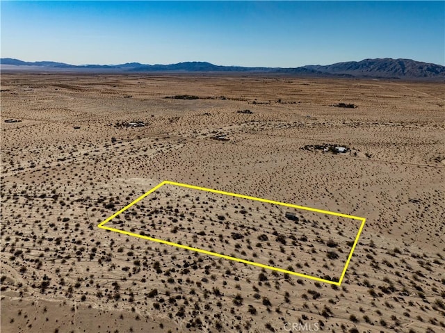 bird's eye view featuring a desert view and a mountain view