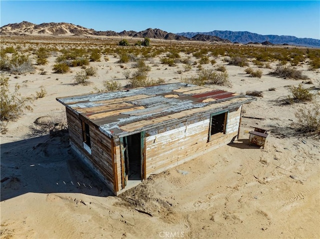 view of outbuilding featuring view of desert and a mountain view