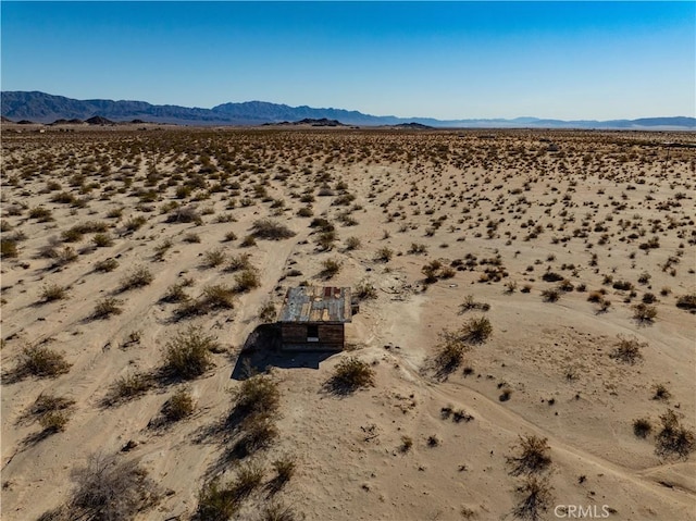 aerial view featuring a desert view and a mountain view