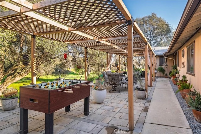 view of patio featuring outdoor dining space and a pergola