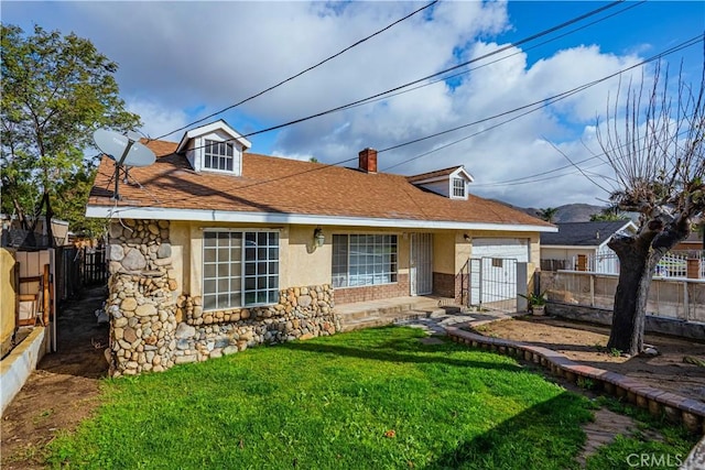 view of front of home with stucco siding, stone siding, a fenced backyard, a front yard, and a chimney